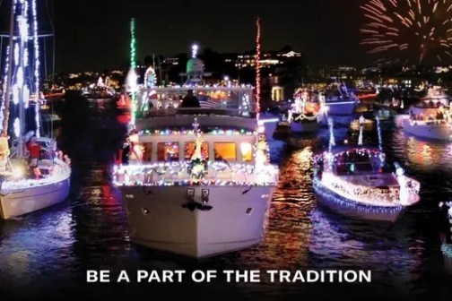 Boats decorated with lights on water, fireworks in sky.