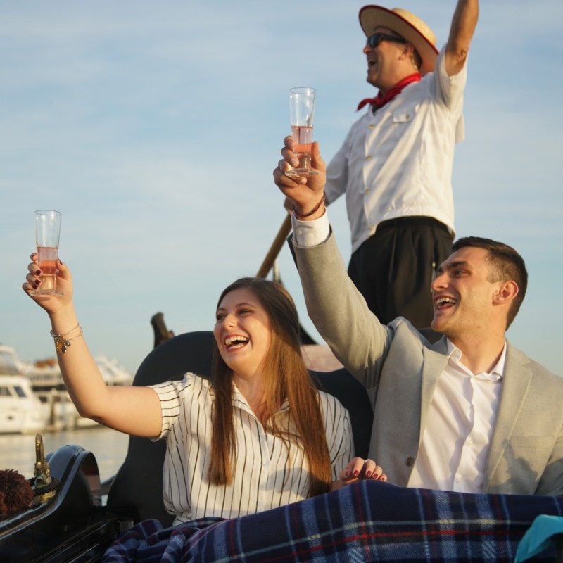 a group of people are drinking from a bottle