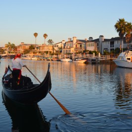 gondolier taking cruise into sunset