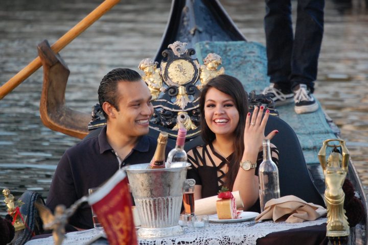Alma Ordoñez et al. sitting at a table with a cup of water