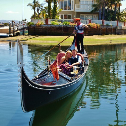 couple smiling on gondola during nice day