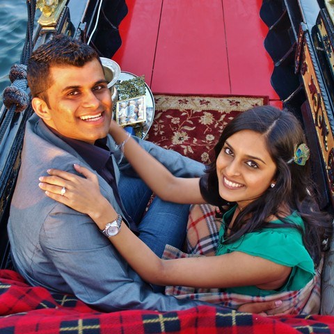 couple smiling with chocolates in gondola