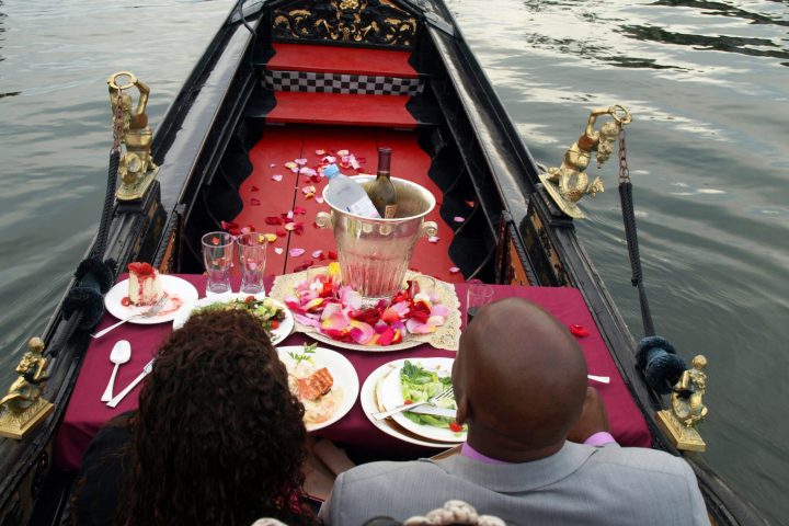 a group of people sitting in a boat on a body of water