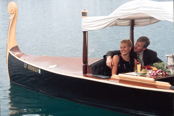 a person sitting at a table in front of a body of water