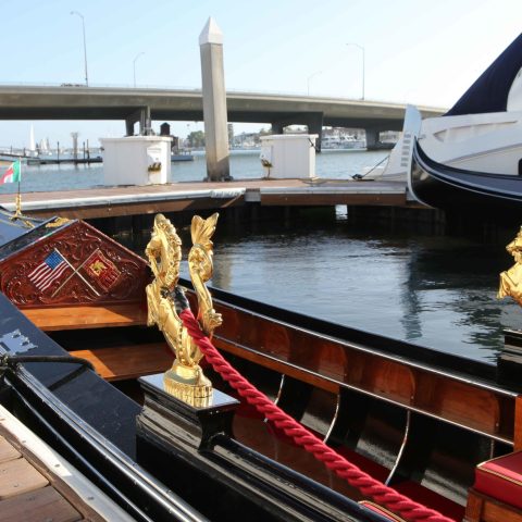 a boat sitting on top of a wooden dock over some water